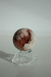 A deep pink and pale white amethyst mini sphere with shimmering pink druzy