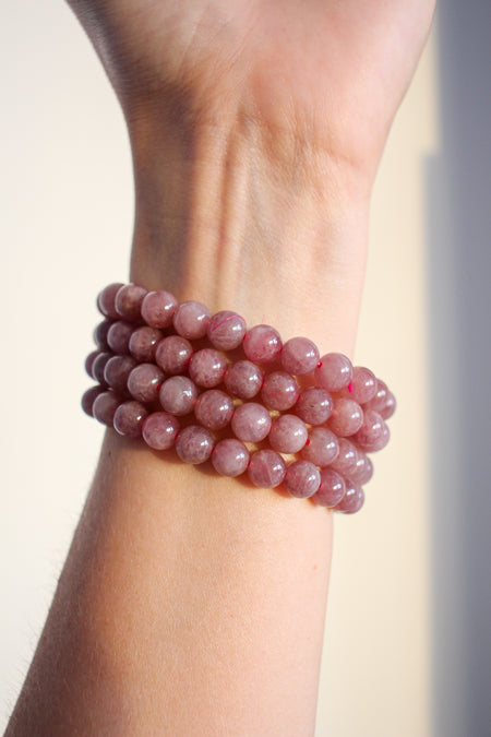 A stack of four pale Pink Amethyst bracelets against a white background 