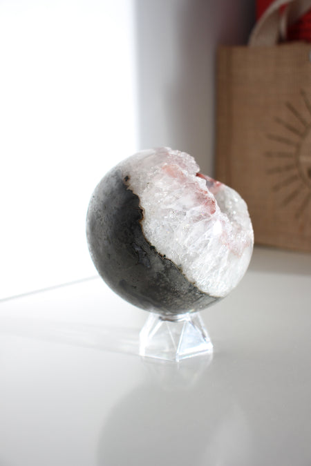 White Amethyst sphere with hematite inclusion