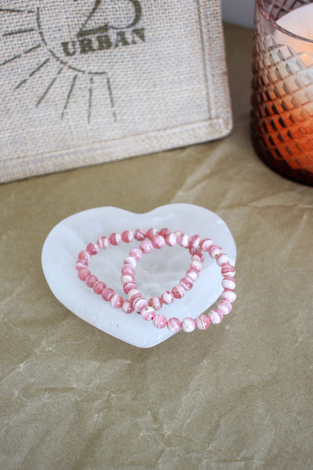 Two beautiful cream and pink Rhodochrosite bracelets in a selenite bowl