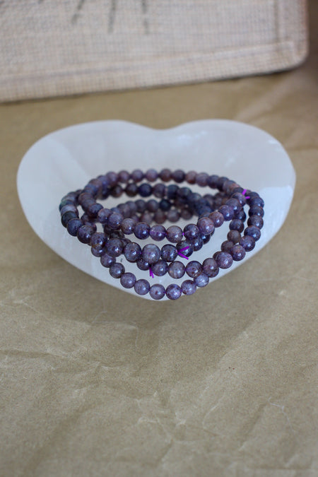Iolite bracelets showing all their shimmering purple and deep red colours 