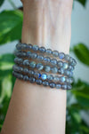 A stack of 5 Labradorite bracelets with blue flash are on a wrist
