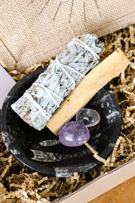 Cleansing Kit from 23 Urban, containing White Sage, Palo Santo, Clear Quartz, Amethyst and a Black Marble Fossil Bowl. 