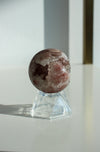 A deep pink and pale white amethyst mini sphere with shimmering pink druzy