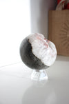 White Amethyst sphere with hematite inclusion