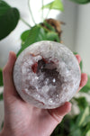 White Amethyst sphere with hematite inclusion