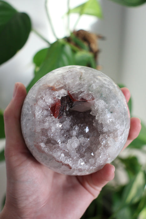 White Amethyst sphere with hematite inclusion