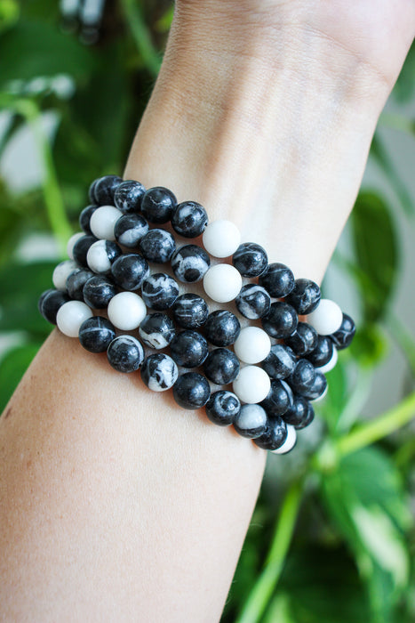 A stack of five zebra jasper bracelets