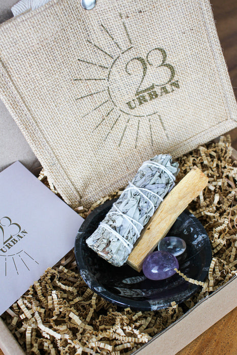 Cleansing Kit from 23 Urban, containing White Sage, Palo Santo, Clear Quartz, Amethyst and a Black Marble Fossil Bowl. 